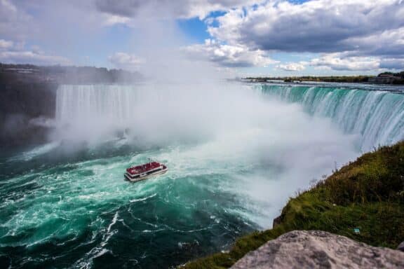 Boot der Niagara City Cruises fährt auf die Niagarafälle zu.
